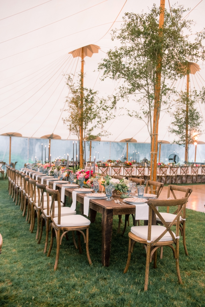 “The tent was gorgeous, but very tall,” says florist Anne. “Adding oak branches to the poles made the space more intimate.” &lt;i&gt;Image by Timwill Photography&lt;/i&gt;