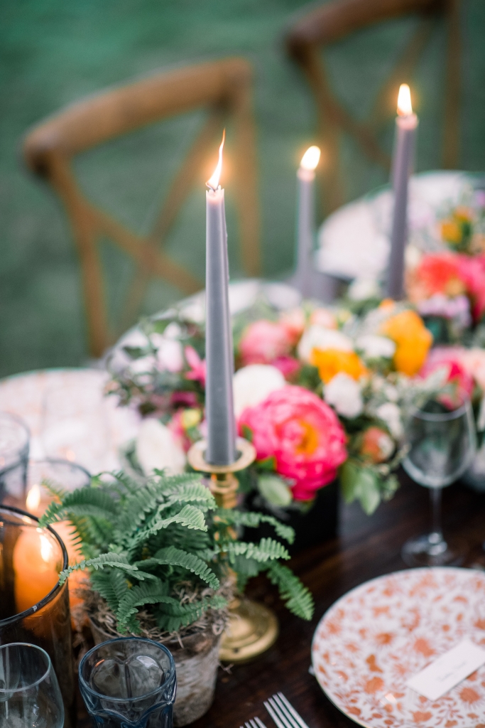 “We wanted the tablescape to be cohesive, but not too manicured,” says planner Chloe Ewing. The result was an earthy mix of terra cotta, metallics, succulents, glowing votives, and blue taper candles—a nod to Jane’s favorite hue. &lt;i&gt;Image by Timwill Photography&lt;/i&gt;