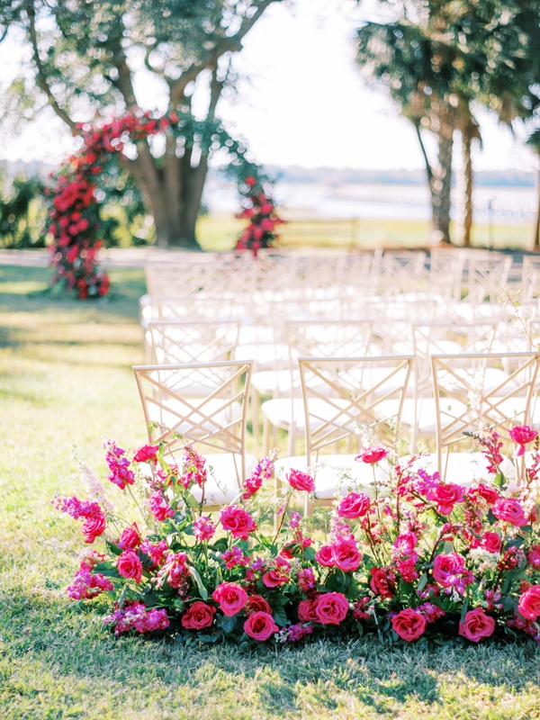Varieties of roses—’Pink Floyd,’ ‘David Austin Tess,’ and ‘Darcy Garden’—gave the reception its hot pink theme.