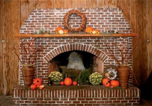 HAVE A HEARTH: Inexpensive—but colorful—fall trappings like mums, pumpkins, and vines suited the rustic look of the location.