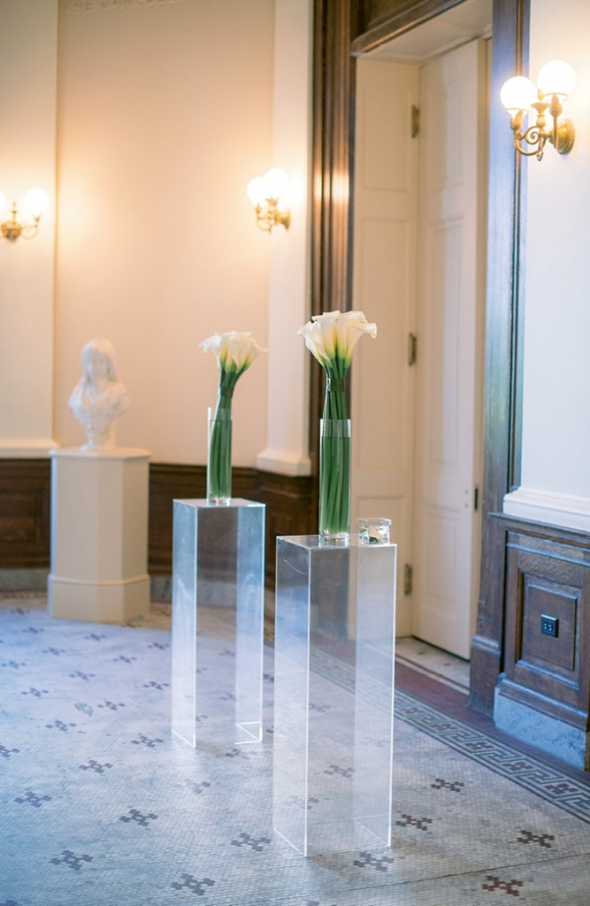 Calla lily arrangements resting on Lucite pillars formed the “altar.”   &lt;i&gt;Image Timwill Photography&lt;/i&gt;
