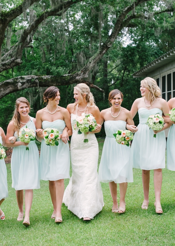 Bouquets by First Bloom of Charleston. Bridesmaid attire through Bella Bridesmaids. Bride’s gown by WTOO through Bridals by Jodi. Image by Britt Croft Photography.