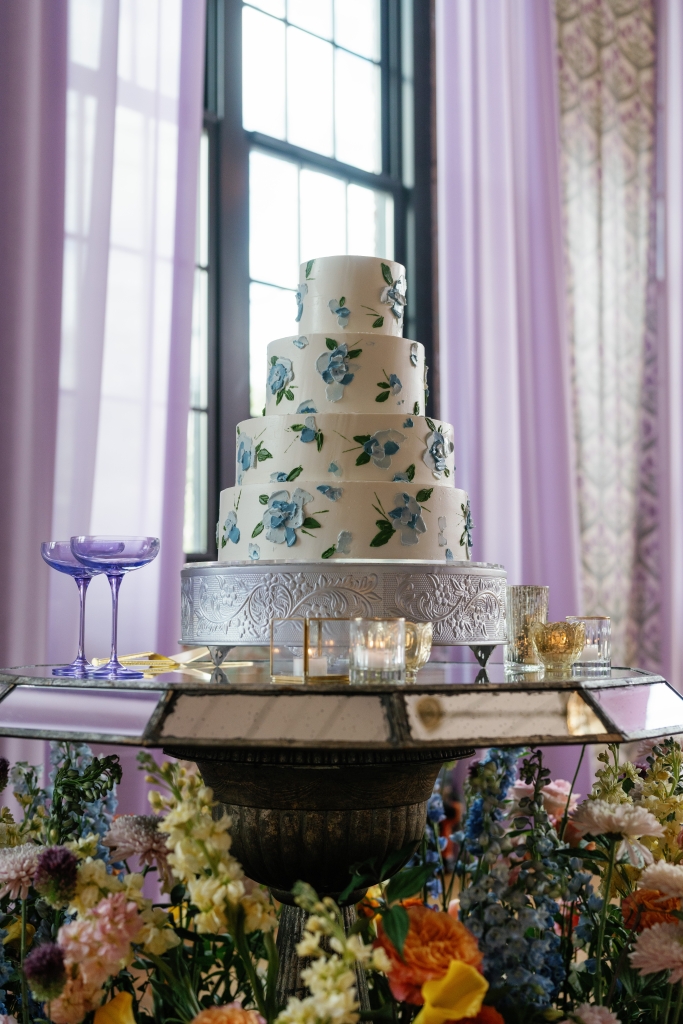 After tasting the wedding cake adorned in blue blooms by ABCD, the couple toasted with Estelle Colored Glass purple coupes.