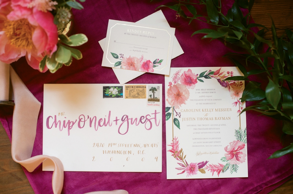 Studio R Designs painted a flower frame on the couple’s gilded edge invitations, which J.Lily Designs addressed.