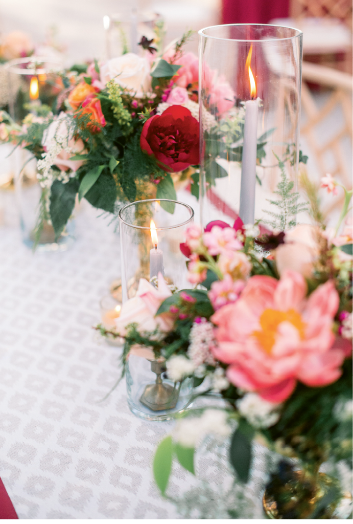 Roses, peonies, and viburnum berries sat atop table runners by the bride’s company, The Social Spool.