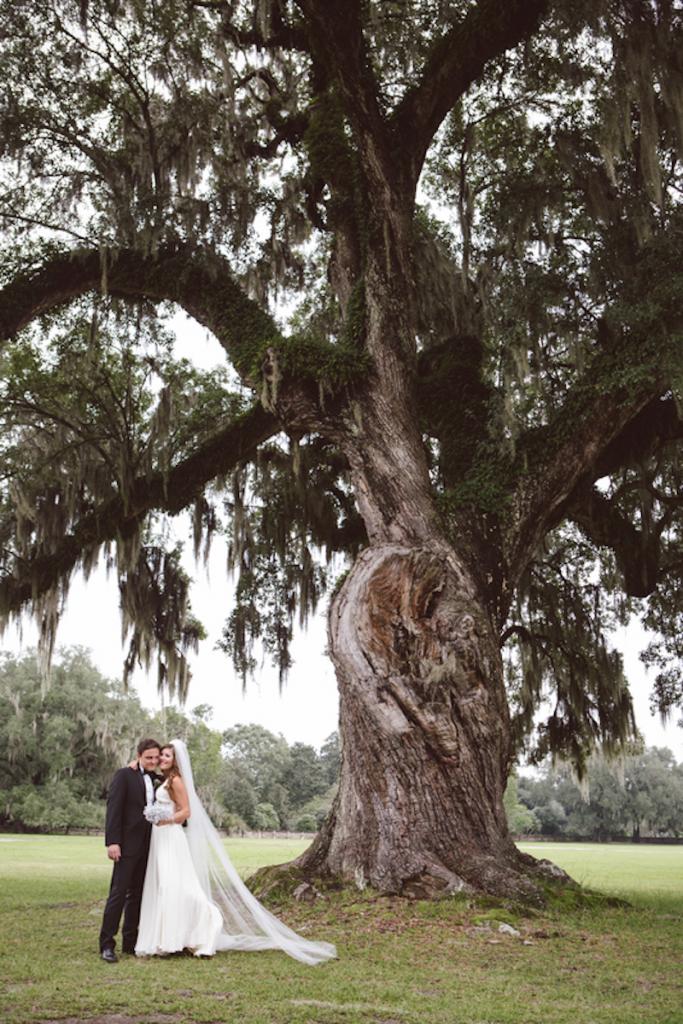 Bride&#039;s gown by Jenny Packham from White on Daniel Island. Menswear from Charleston Tuxedo. Image by amelia + dan photography at Middleton Place.