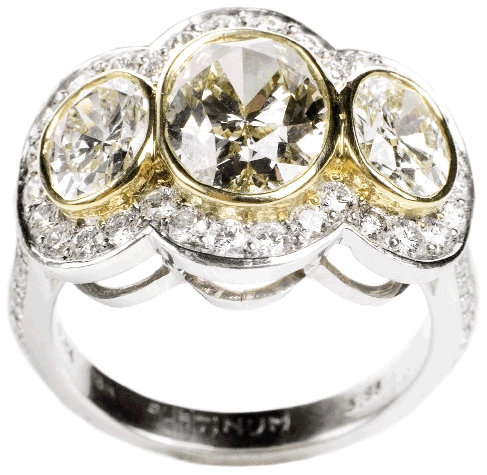 THREE TIMES THE CHARM:  Platinum ring with 18K yellow gold, 2.51 ct.  center diamond, and two yellow diamonds with accent diamonds (2.31 total ct.) Skatell’s, $35,750